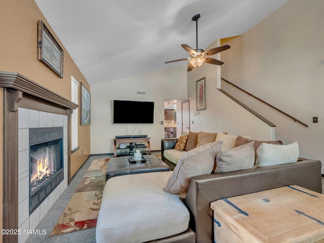 3114 N Connor St, Flagstaff, AZ 86004 - living room with lofted ceiling, carpet flooring, a ceiling fan, and a tiled fireplace