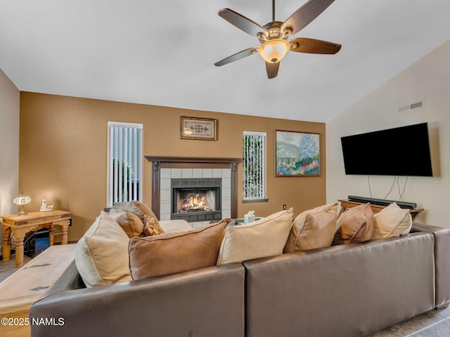 3114 N Connor St, Flagstaff, AZ 86004 - living room featuring a tiled fireplace, a ceiling fan, and lofted ceiling