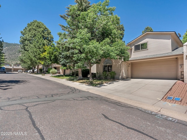 3114 N Connor St, Flagstaff, AZ 86004 - view of front facade with an attached garage, driveway, and brick siding