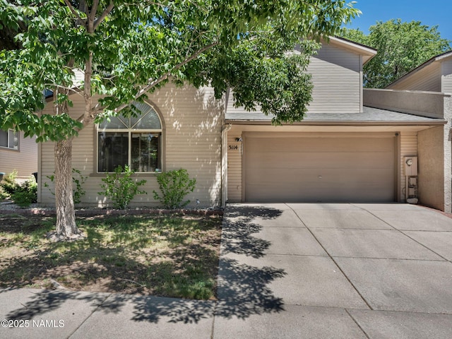 3114 N Connor St, Flagstaff, AZ 86004 - obstructed view of property featuring an attached garage and driveway