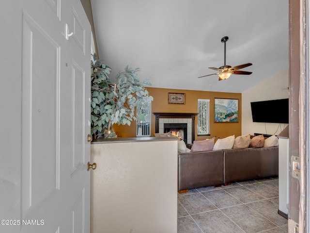3114 N Connor St, Flagstaff, AZ 86004 - living area with a tile fireplace, lofted ceiling, a ceiling fan, and light tile patterned flooring