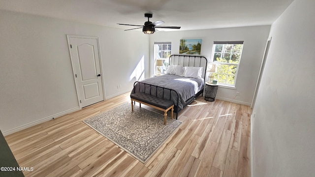 bedroom with ceiling fan and light hardwood / wood-style flooring