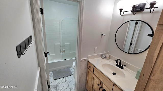 full bathroom featuring shower / bath combination with glass door, vanity, and toilet