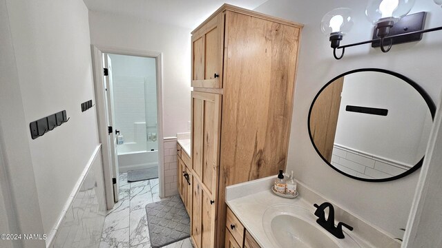 bathroom with vanity, shower / bathtub combination, and an inviting chandelier