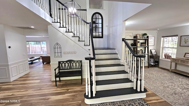 staircase with hardwood / wood-style flooring and a wealth of natural light