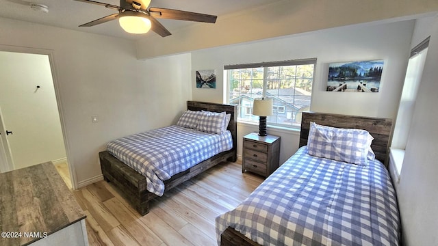 bedroom with light wood-type flooring and ceiling fan