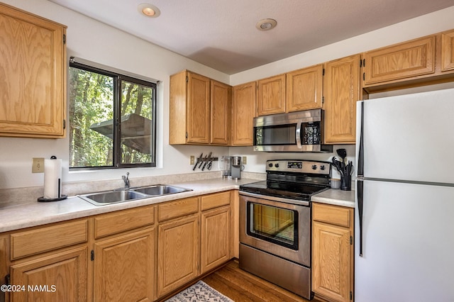 335 Sandia Cir, Munds Park, AZ 86017 - kitchen with appliances with stainless steel finishes, a sink, light countertops, and dark wood-style floors