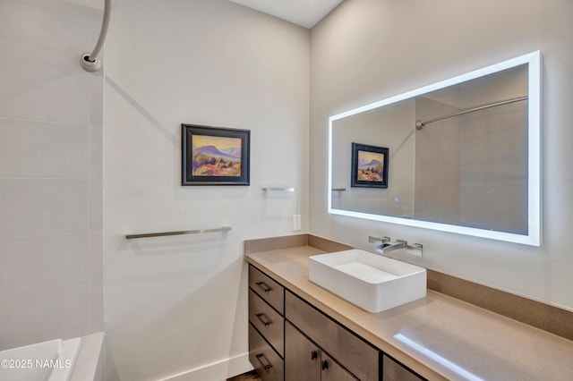 bathroom featuring a tile shower and vanity
