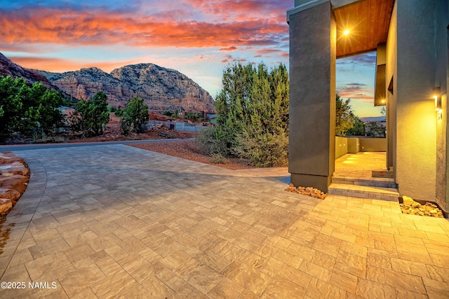 view of swimming pool with a patio and a mountain view