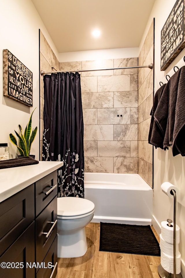full bathroom featuring shower / bath combo with shower curtain, wood finished floors, toilet, and vanity