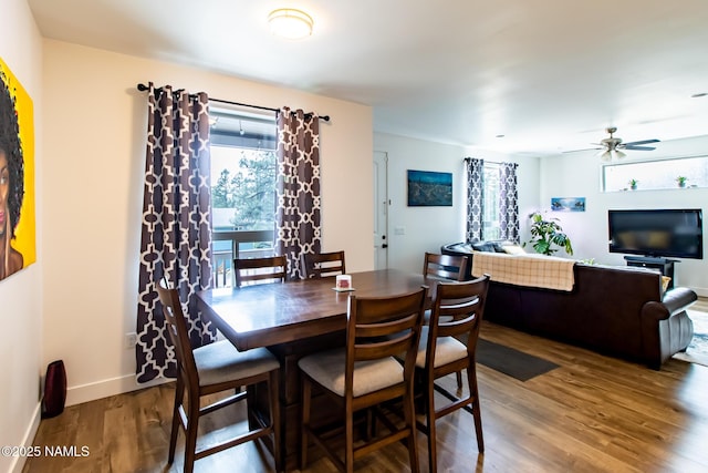 dining area featuring a ceiling fan, baseboards, and wood finished floors