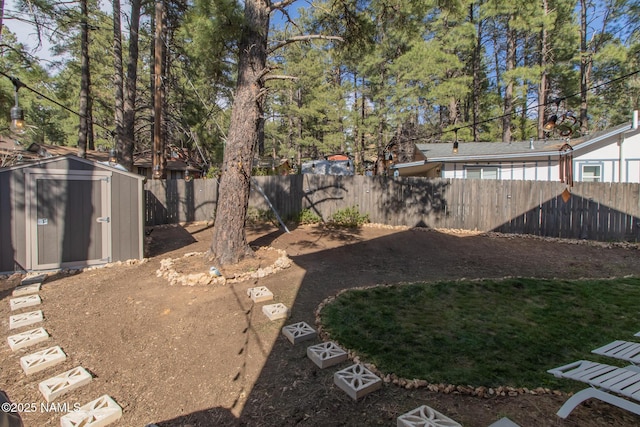 view of yard with a fenced backyard, an outbuilding, and a storage shed