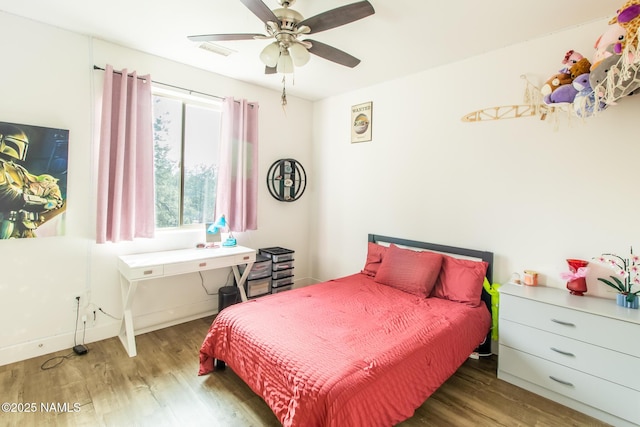 bedroom with visible vents, ceiling fan, and wood finished floors