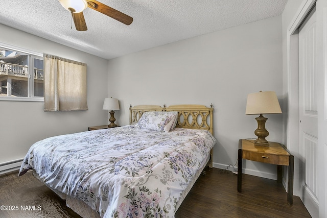 bedroom with baseboards, wood finished floors, a closet, a textured ceiling, and a ceiling fan