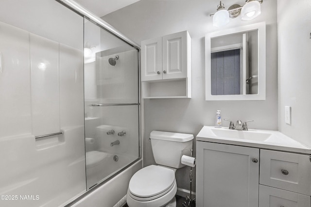 full bathroom with toilet, vanity, and bath / shower combo with glass door