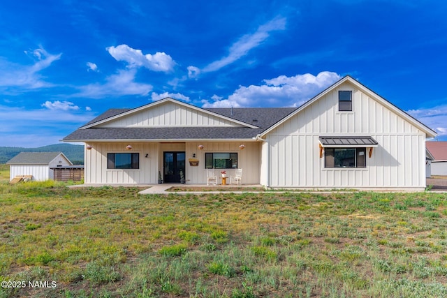 6552 Kelsey Springs Way, Flagstaff, AZ 86001 - rear view of house with roof with shingles, board and batten siding, and a lawn