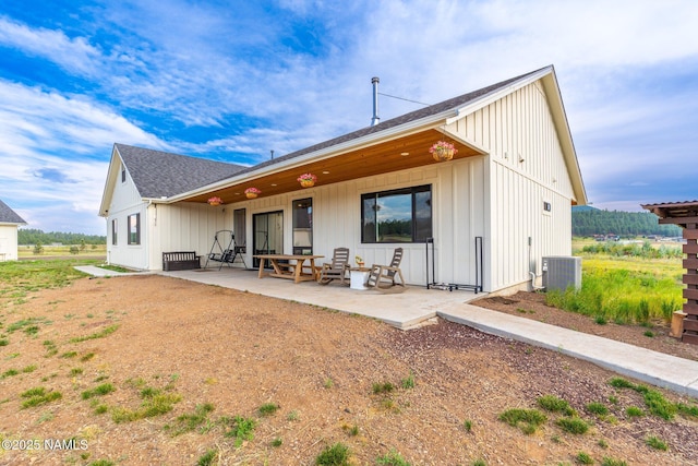 6552 Kelsey Springs Way, Flagstaff, AZ 86001 - rear view of house with central air condition unit, a shingled roof, board and batten siding, and a patio