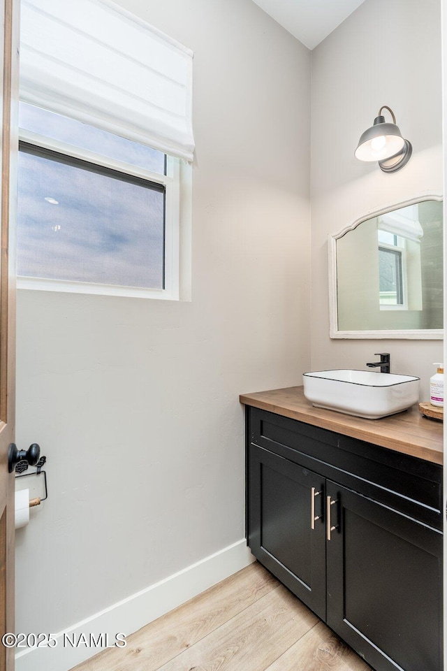 6552 Kelsey Springs Way, Flagstaff, AZ 86001 - bathroom with wood finished floors, baseboards, healthy amount of natural light, and vanity
