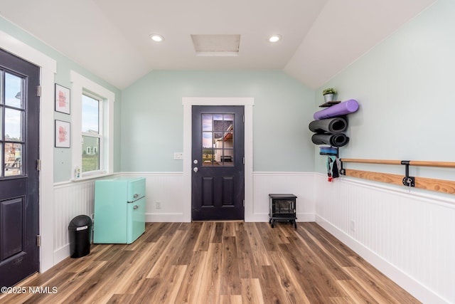 6552 Kelsey Springs Way, Flagstaff, AZ 86001 - foyer featuring a wainscoted wall, wood finished floors, lofted ceiling, a wood stove, and recessed lighting
