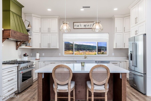6552 Kelsey Springs Way, Flagstaff, AZ 86001 - kitchen featuring high end appliances, a sink, light countertops, white cabinetry, and recessed lighting
