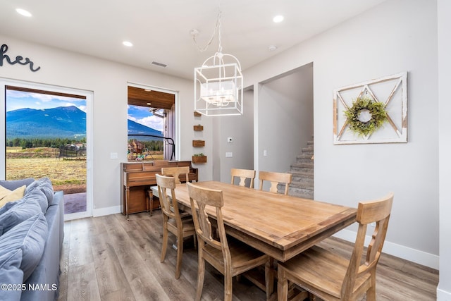 6552 Kelsey Springs Way, Flagstaff, AZ 86001 - dining area with a chandelier, stairs, light wood-style floors, recessed lighting, and baseboards