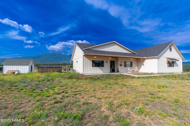 6552 Kelsey Springs Way, Flagstaff, AZ 86001 - back of property with a mountain view, an outbuilding, board and batten siding, roof with shingles, and a storage unit