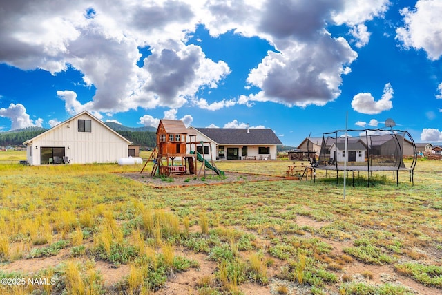 6552 Kelsey Springs Way, Flagstaff, AZ 86001 - view of grassy yard featuring a trampoline and a playground