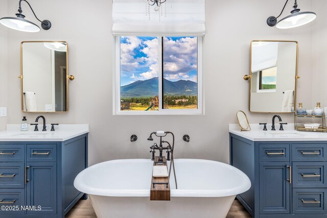 6552 Kelsey Springs Way, Flagstaff, AZ 86001 - full bath with two vanities, a freestanding tub, and wood finished floors