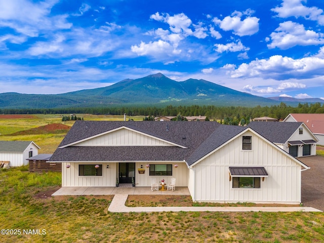 6552 Kelsey Springs Way, Flagstaff, AZ 86001 - modern farmhouse featuring board and batten siding, a mountain view, and roof with shingles