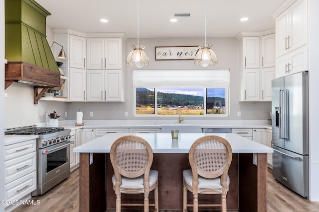 6552 Kelsey Springs Way, Flagstaff, AZ 86001 - kitchen featuring high end appliances, a sink, light countertops, white cabinetry, and recessed lighting