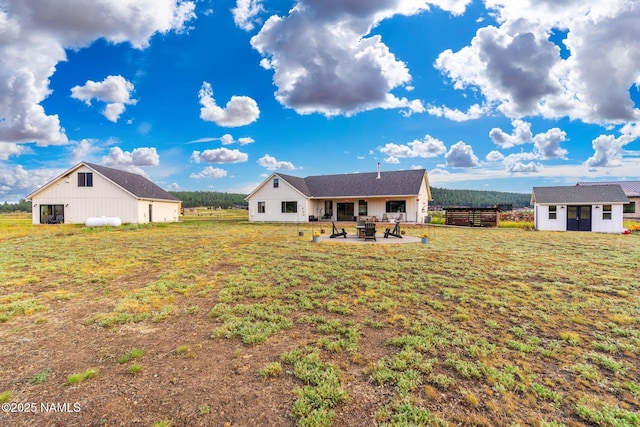 6552 Kelsey Springs Way, Flagstaff, AZ 86001 - rear view of house with an outdoor structure, a lawn, and a patio area