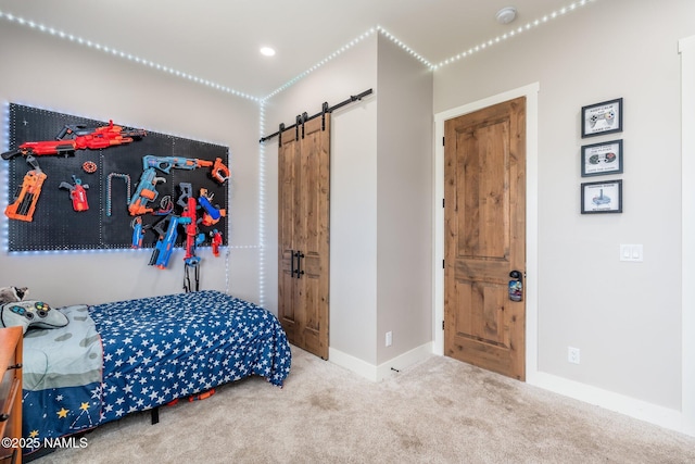 6552 Kelsey Springs Way, Flagstaff, AZ 86001 - bedroom with a barn door, carpet floors, and baseboards