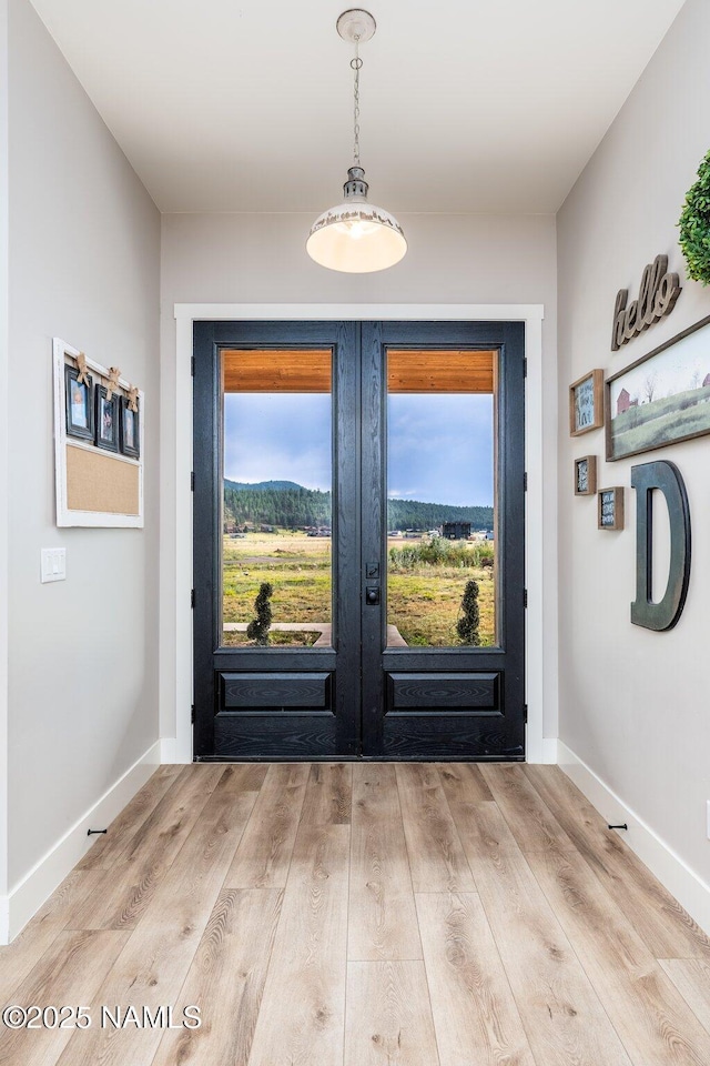 6552 Kelsey Springs Way, Flagstaff, AZ 86001 - doorway featuring french doors, wood finished floors, and baseboards