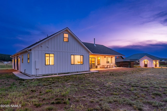 6552 Kelsey Springs Way, Flagstaff, AZ 86001 - back of property with board and batten siding, an outbuilding, a storage unit, and a patio