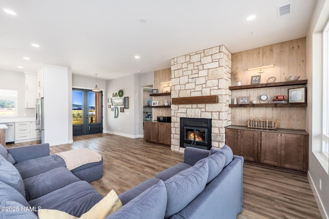 6552 Kelsey Springs Way, Flagstaff, AZ 86001 - living area featuring wood finished floors, baseboards, a fireplace, recessed lighting, and wood walls
