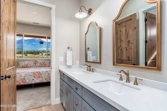 6552 Kelsey Springs Way, Flagstaff, AZ 86001 - bathroom with wood finished floors, double vanity, and connected bathroom