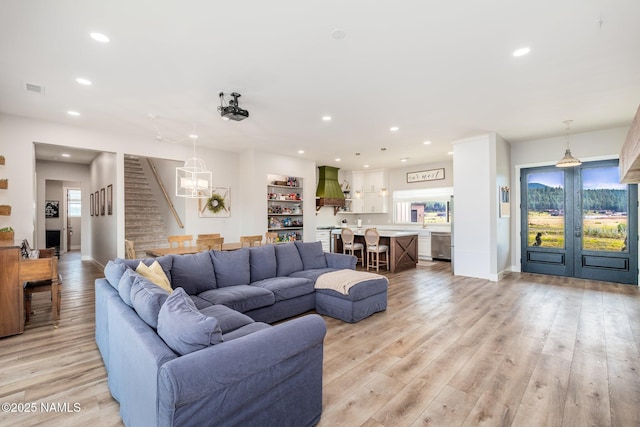6552 Kelsey Springs Way, Flagstaff, AZ 86001 - living area featuring recessed lighting, light wood-style flooring, a chandelier, french doors, and baseboards