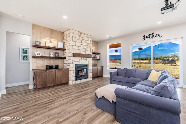 6552 Kelsey Springs Way, Flagstaff, AZ 86001 - living area with healthy amount of natural light, light wood finished floors, baseboards, recessed lighting, and a stone fireplace