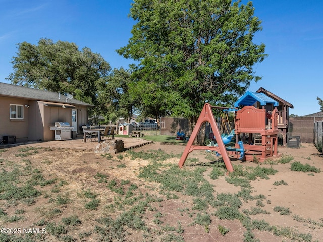 7776 Moonbeam Dr, Flagstaff, AZ 86004 - fenced backyard with a playground and a patio area