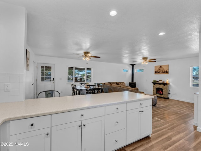 7776 Moonbeam Dr, Flagstaff, AZ 86004 - kitchen with a ceiling fan, open floor plan, white cabinets, healthy amount of natural light, and recessed lighting