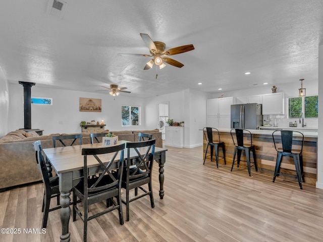 7776 Moonbeam Dr, Flagstaff, AZ 86004 - dining room with a textured ceiling, light wood-style flooring, ceiling fan, recessed lighting, and plenty of natural light