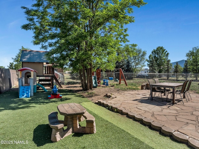 7776 Moonbeam Dr, Flagstaff, AZ 86004 - fenced backyard featuring a playground and a patio