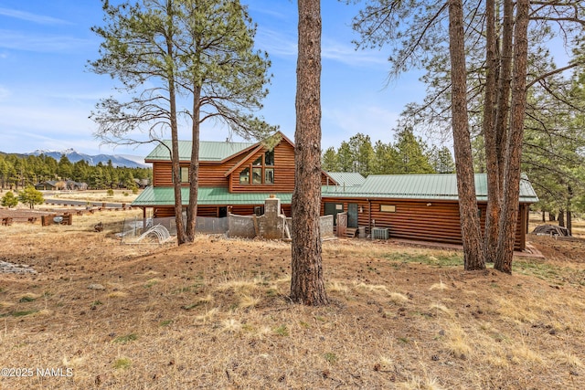 4536 Brackin Ranch Rd, Flagstaff, AZ 86001 - rear view of house with metal roof, a mountain view, log veneer siding, and central AC unit