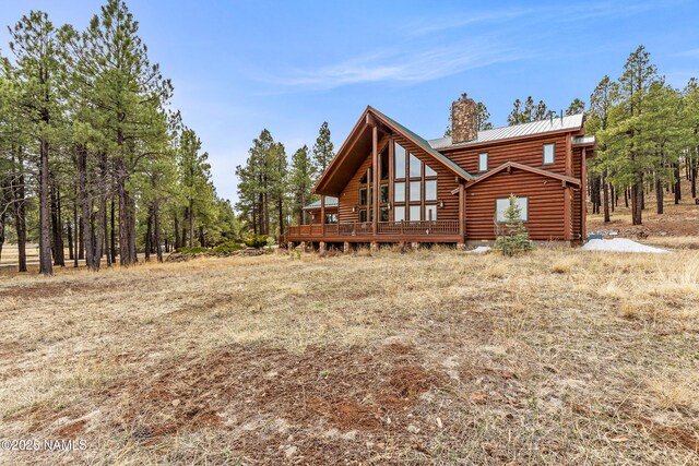 4536 Brackin Ranch Rd, Flagstaff, AZ 86001 - rear view of property featuring a chimney, metal roof, a deck, and log siding