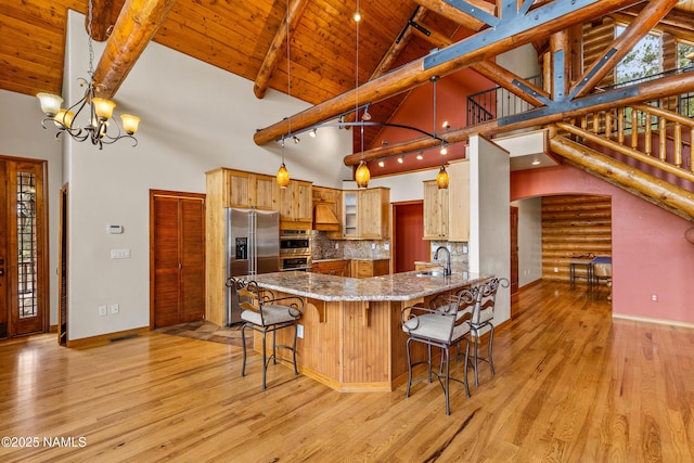 4536 Brackin Ranch Rd, Flagstaff, AZ 86001 - kitchen featuring stainless steel fridge, a sink, wood ceiling with exposed beams, high vaulted ceiling, and light wood finished floors