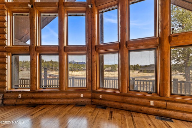 4536 Brackin Ranch Rd, Flagstaff, AZ 86001 - detailed view of log walls, wood finished floors, and a mountainous background