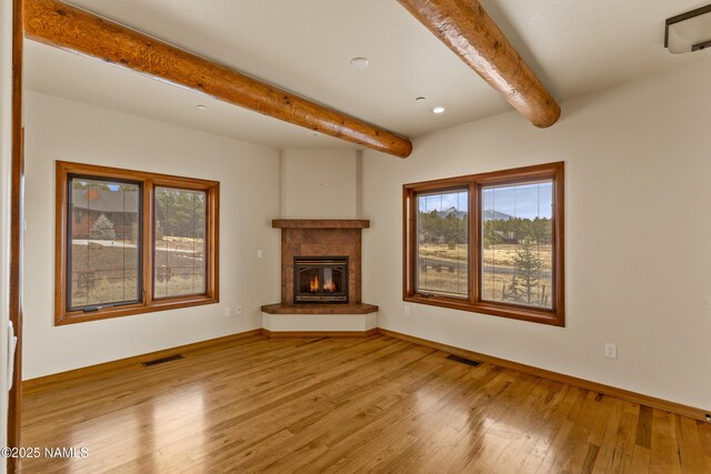 4536 Brackin Ranch Rd, Flagstaff, AZ 86001 - unfurnished living room featuring beamed ceiling, wood-type flooring, baseboards, a tiled fireplace, and recessed lighting