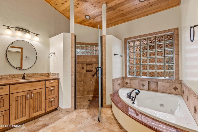 4536 Brackin Ranch Rd, Flagstaff, AZ 86001 - full bathroom featuring wooden ceiling, a shower stall, a tub with jets, and vanity