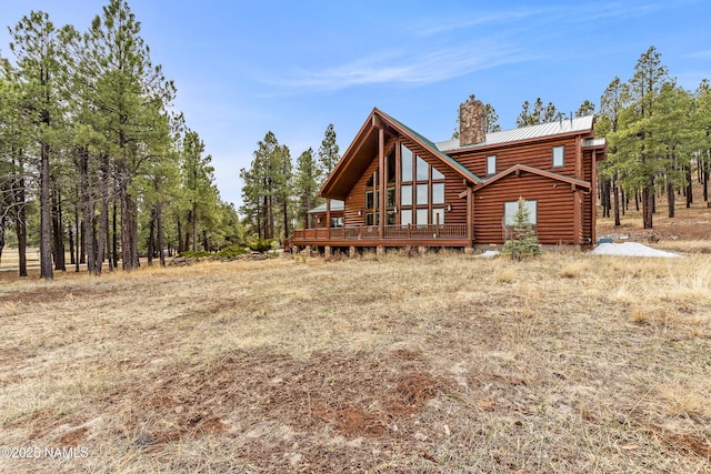 4536 Brackin Ranch Rd, Flagstaff, AZ 86001 - rear view of property featuring a chimney, metal roof, a deck, and log siding
