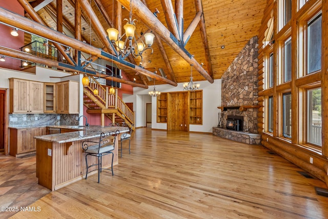 4536 Brackin Ranch Rd, Flagstaff, AZ 86001 - kitchen featuring a chandelier, high vaulted ceiling, wood ceiling with exposed beams, open shelves, and light wood finished floors